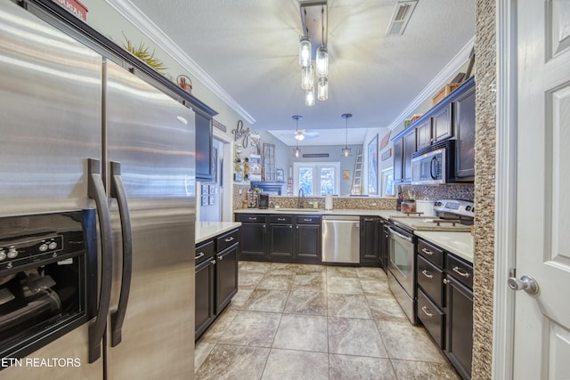 kitchen featuring stainless steel appliances, light countertops, visible vents, and ornamental molding