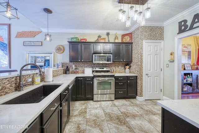 kitchen featuring ornamental molding, stainless steel appliances, a sink, and decorative light fixtures