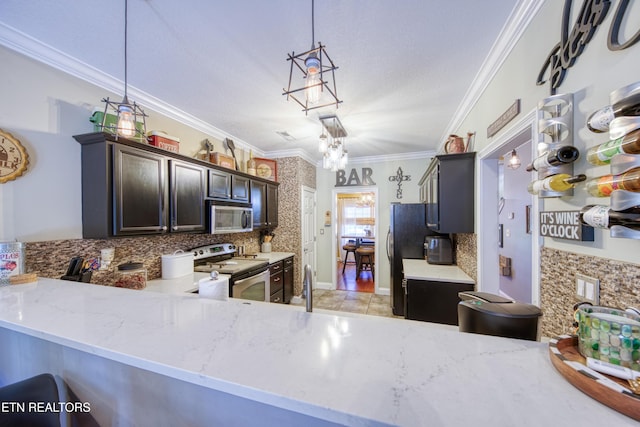 kitchen featuring light stone counters, stainless steel appliances, decorative backsplash, decorative light fixtures, and crown molding