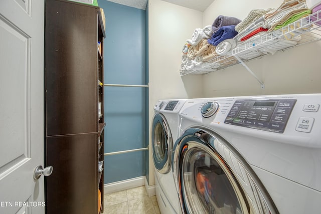 laundry room featuring washing machine and dryer, laundry area, and light tile patterned floors