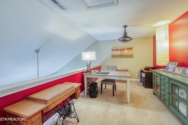 carpeted office space with vaulted ceiling, visible vents, and baseboards