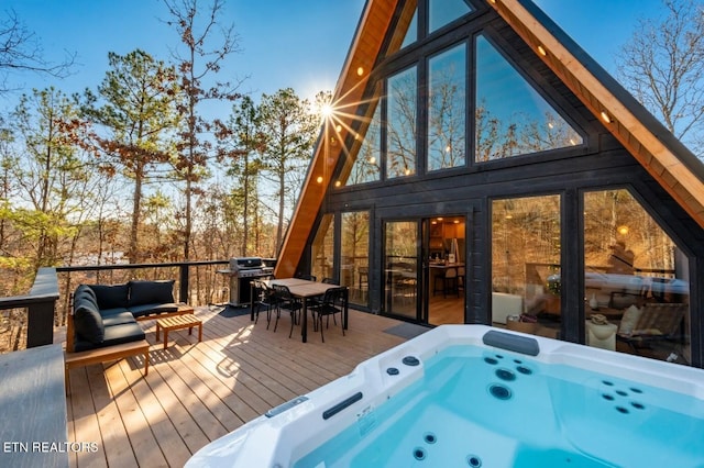 wooden deck featuring a hot tub and grilling area