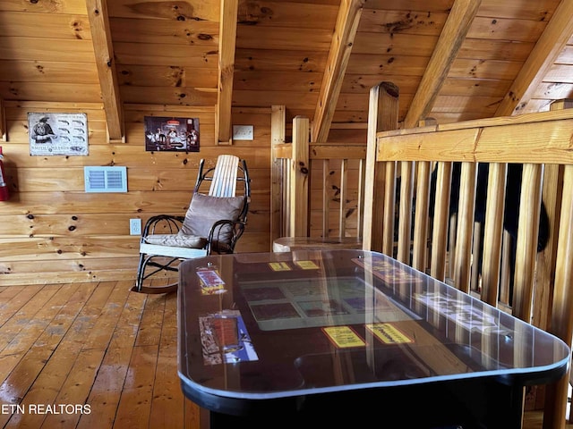 interior space featuring wood ceiling, wood walls, beam ceiling, and hardwood / wood-style flooring