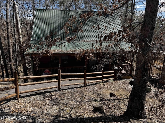 view of side of home featuring metal roof