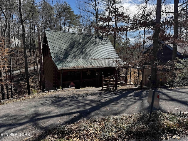 view of front of house with a porch and metal roof