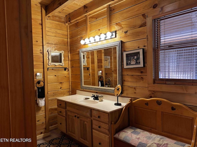 bathroom with wood walls and vanity