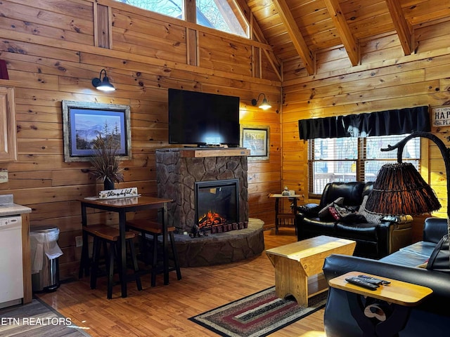 living area with wooden walls, wooden ceiling, and a healthy amount of sunlight