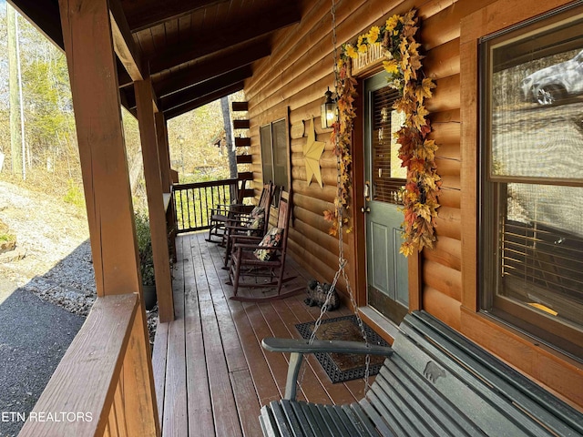 wooden terrace featuring covered porch