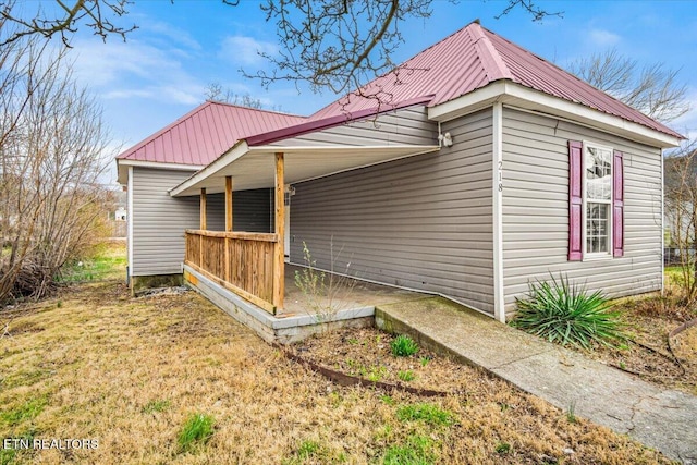 view of side of home with metal roof