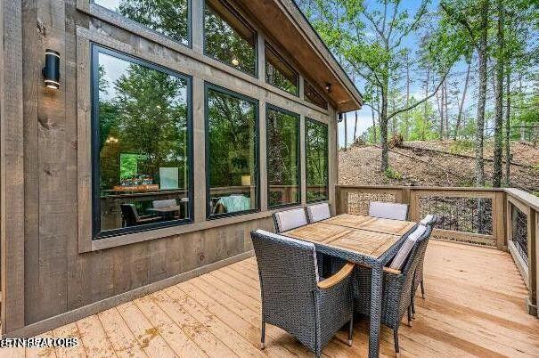 wooden terrace featuring outdoor dining space