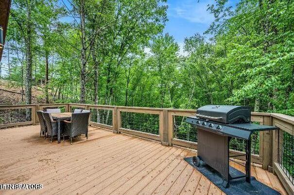 wooden terrace featuring outdoor dining area