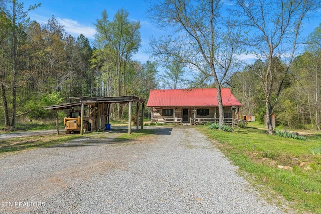 346 Chestuee Rd, Calhoun, TN 37309 - rustic home featuring a detached carport, metal roof, covered porch, and driveway