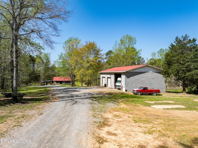 346 Chestuee Rd, Calhoun, TN 37309 - exterior space with an outbuilding, a garage, an outdoor structure, and dirt driveway