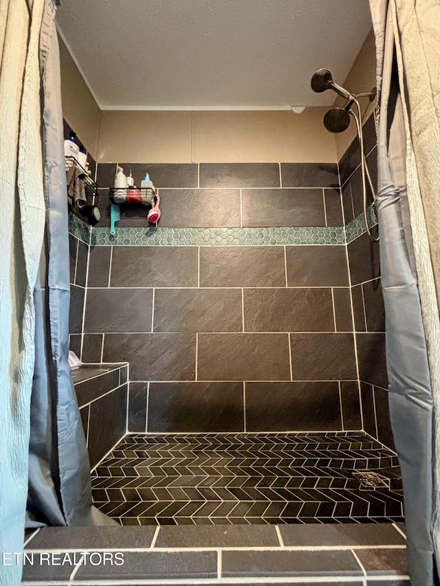 full bathroom with tiled shower