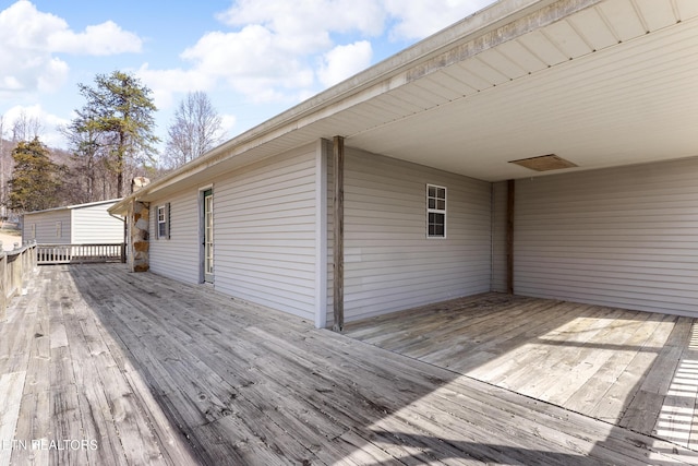 wooden terrace featuring an attached carport
