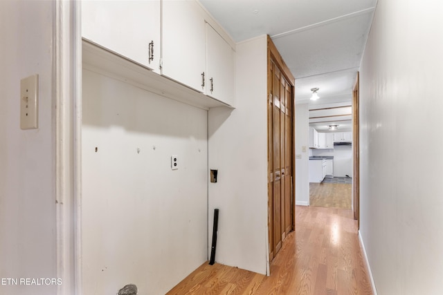 laundry area featuring light wood-style floors