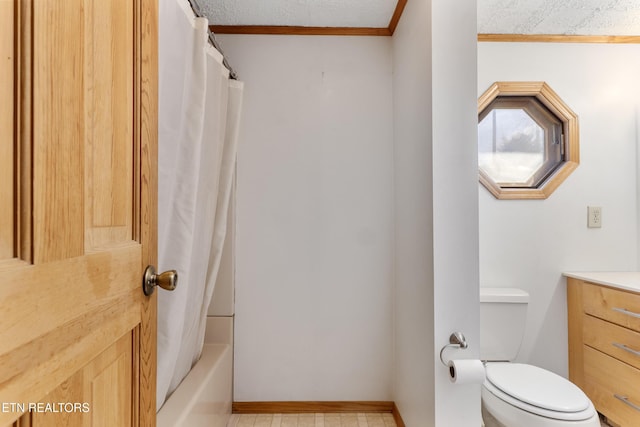 bathroom with crown molding, vanity, toilet, and a textured ceiling