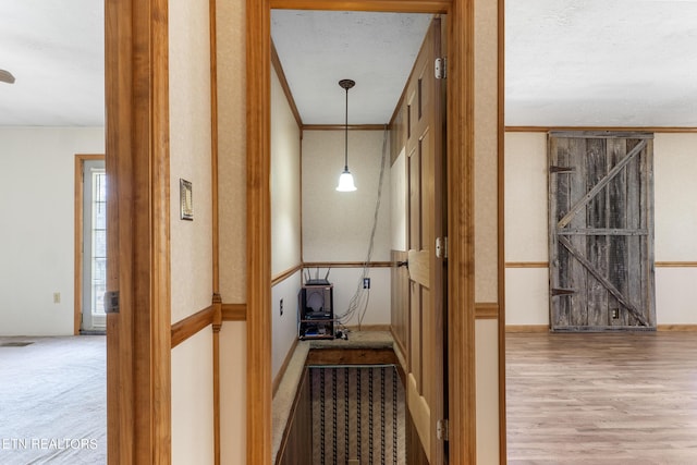 hall featuring ornamental molding and wood finished floors