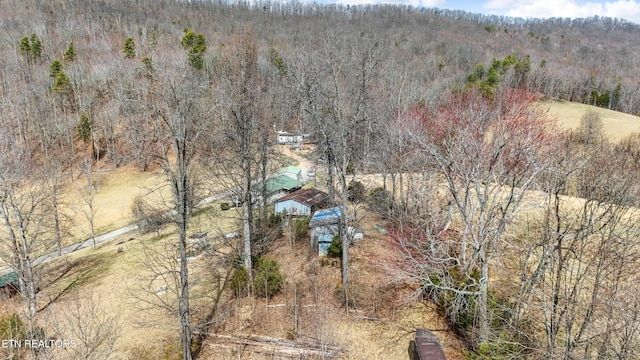 drone / aerial view featuring a forest view
