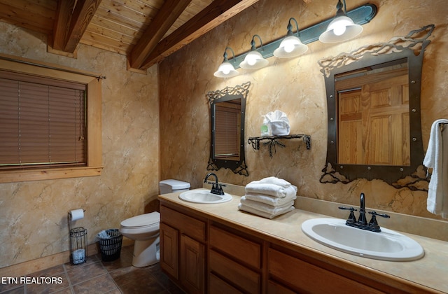 full bathroom featuring beam ceiling, a sink, toilet, and tile patterned floors