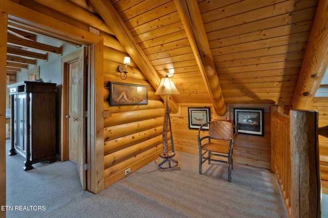 interior space featuring carpet, beam ceiling, wooden ceiling, and log walls