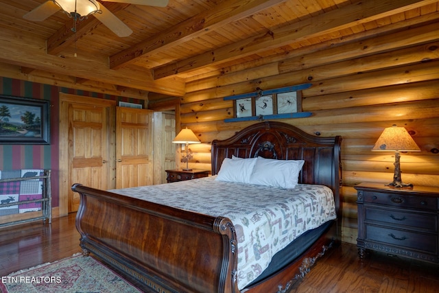 bedroom with dark wood-type flooring, beamed ceiling, rustic walls, and wooden ceiling