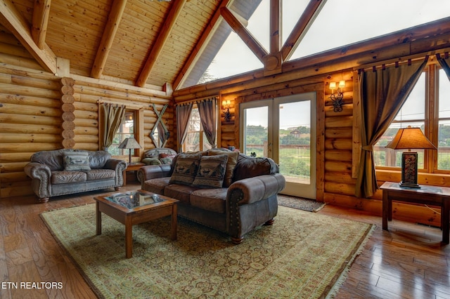 living area featuring wood-type flooring, high vaulted ceiling, and beam ceiling