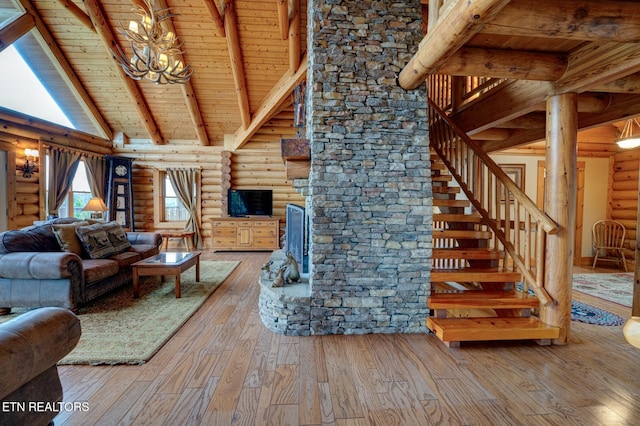 living area featuring wooden ceiling, hardwood / wood-style flooring, stairs, high vaulted ceiling, and beam ceiling