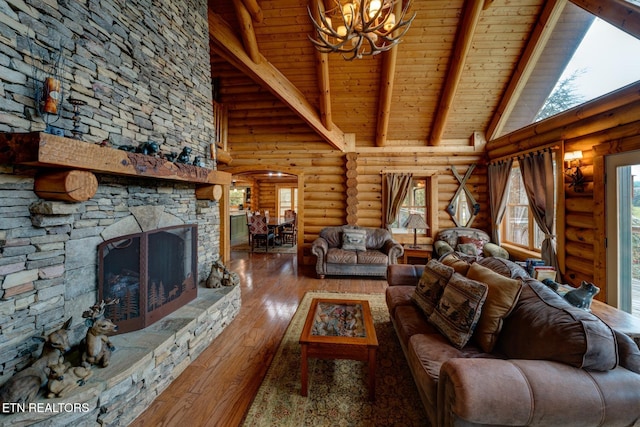 living room featuring a notable chandelier, a fireplace, high vaulted ceiling, beamed ceiling, and hardwood / wood-style floors