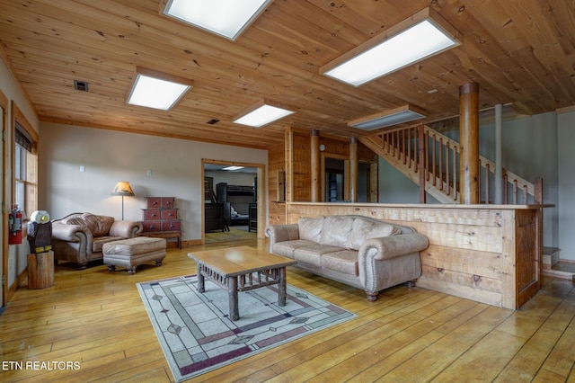 living area featuring light wood-style floors, wood ceiling, vaulted ceiling, and stairway