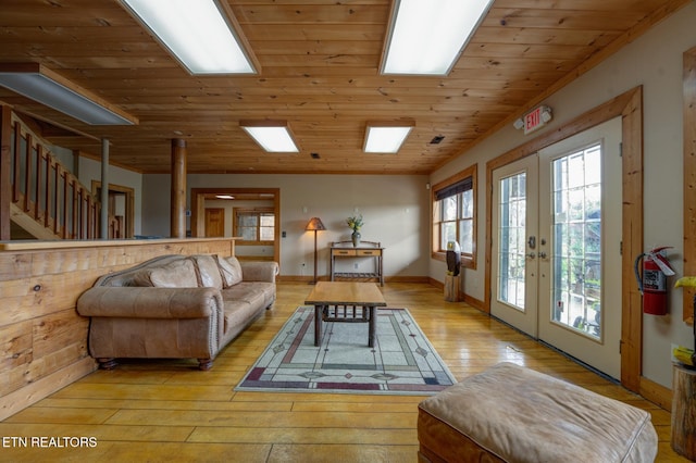 living area featuring lofted ceiling, wood ceiling, baseboards, french doors, and light wood-type flooring