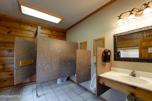 bathroom featuring ornamental molding, tile patterned flooring, a sink, and a shower stall