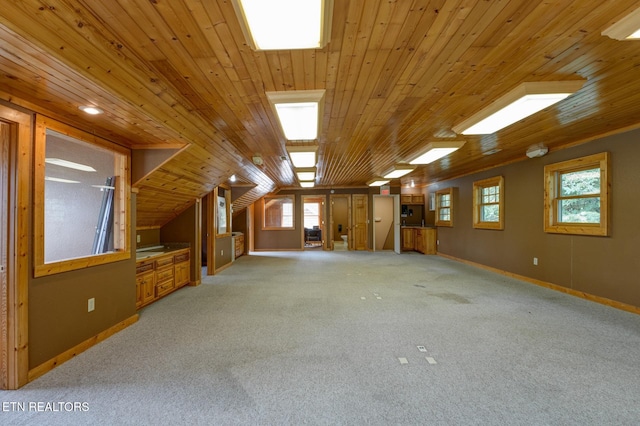 interior space featuring vaulted ceiling, baseboards, wood ceiling, and light colored carpet