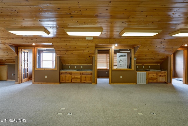 additional living space with lofted ceiling, wood ceiling, visible vents, and light carpet