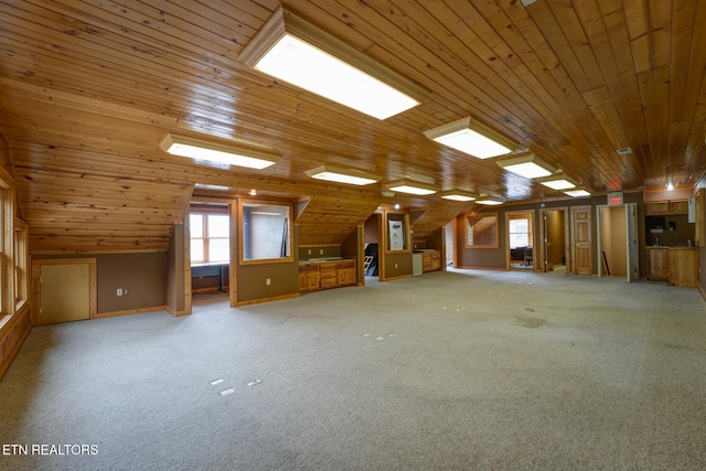 interior space featuring wood ceiling, light carpet, and vaulted ceiling