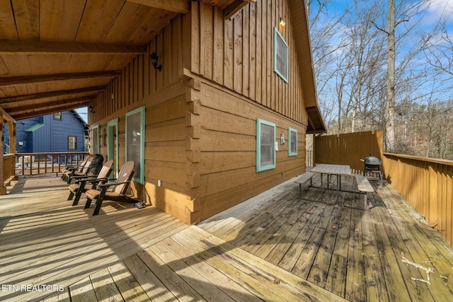 wooden deck with a grill