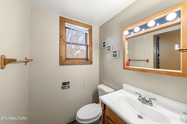 half bathroom featuring toilet and vanity