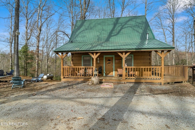 chalet / cabin with covered porch and metal roof