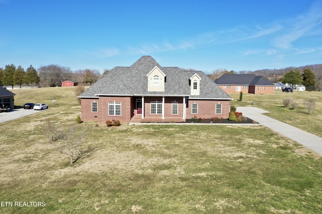 view of front facade featuring crawl space, brick siding, a front lawn, and roof with shingles