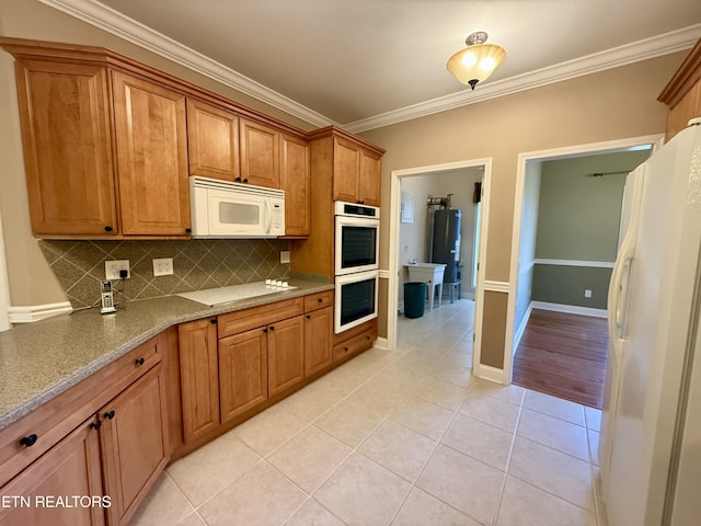 kitchen featuring light tile patterned floors, white appliances, crown molding, and decorative backsplash