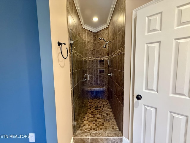 full bathroom featuring a stall shower and crown molding