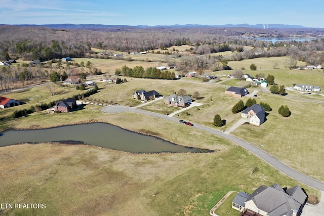 drone / aerial view featuring a water and mountain view