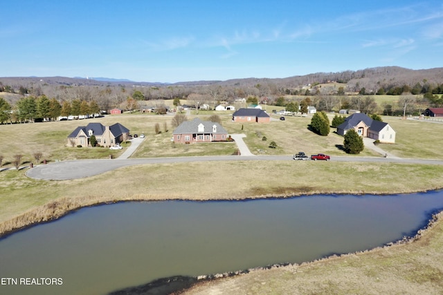 birds eye view of property with a water and mountain view