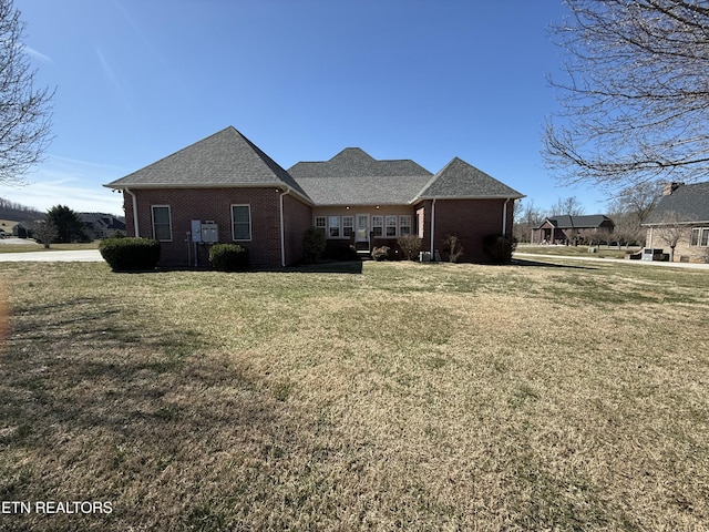 exterior space with a yard and brick siding