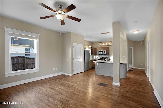 kitchen with visible vents, baseboards, light countertops, appliances with stainless steel finishes, and dark wood-style floors