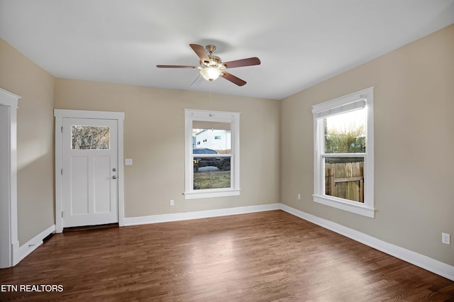 entrance foyer with wood finished floors, a ceiling fan, and baseboards