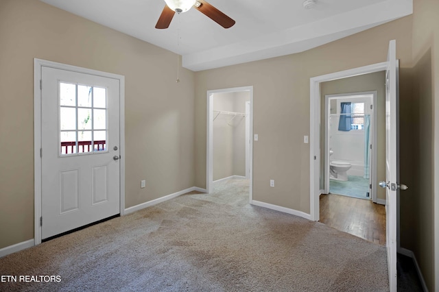 interior space featuring carpet flooring, a wealth of natural light, and baseboards