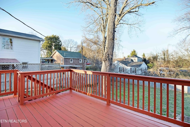 deck with a yard and a residential view