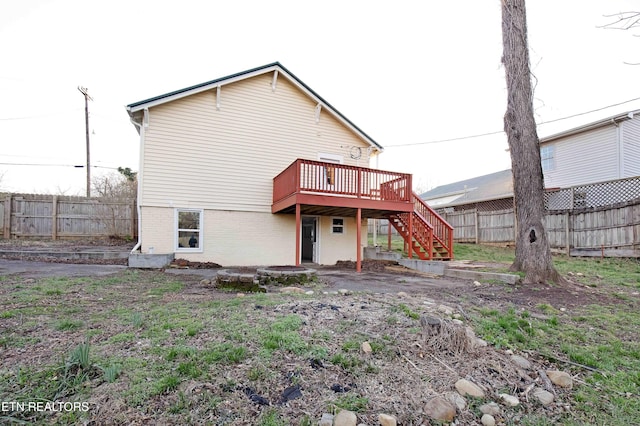 back of house featuring a deck, stairway, and fence private yard