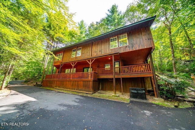 rustic home with a wooded view